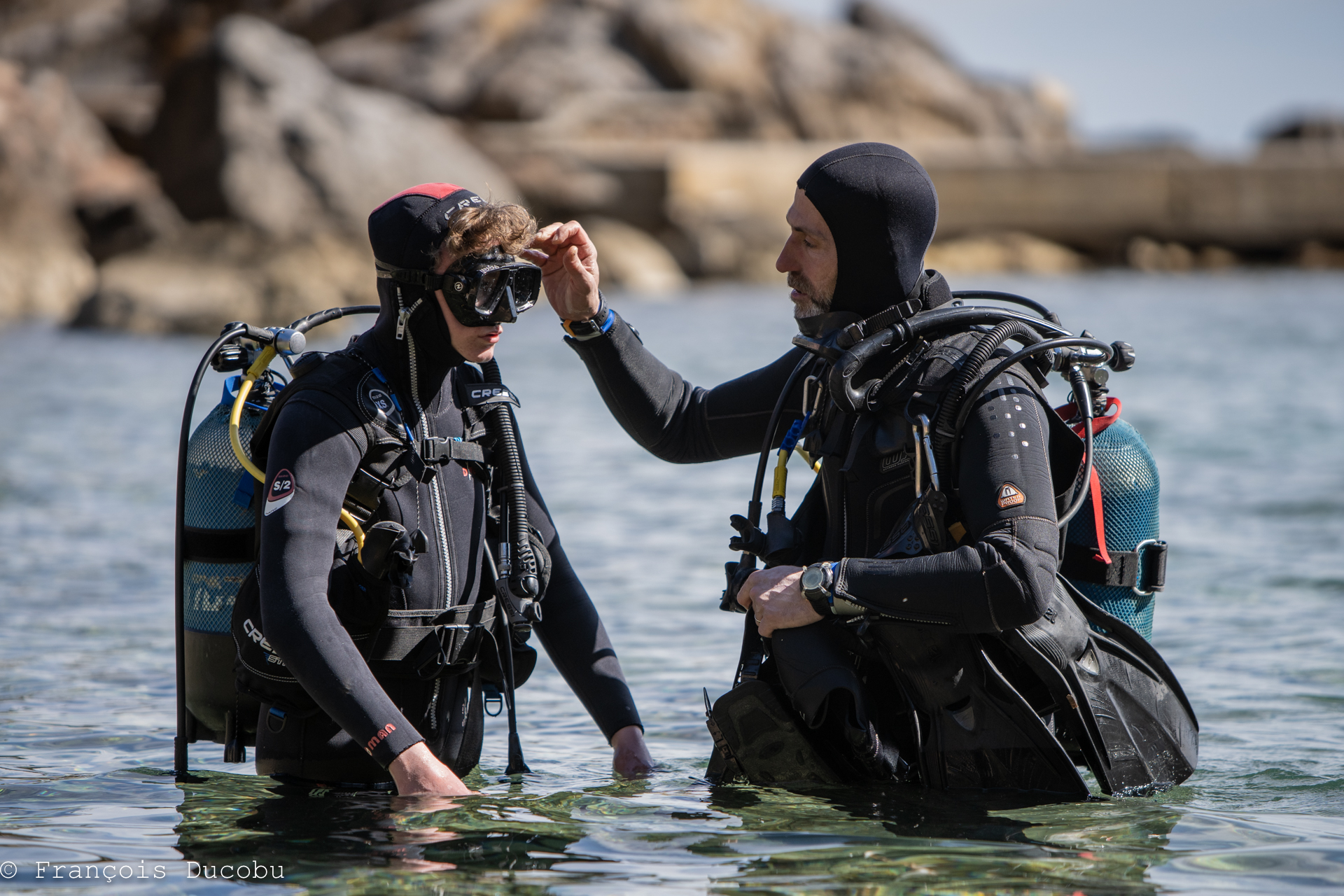 Emilios Seretakis, PADI instructor, helping a student during open water scuba training in Halkidiki, Greece. Dive Greece team.